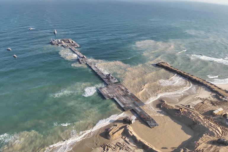 Ships are seen near a temporary floating pier built to receive humanitarian aid in the Gaza Strip in Gaza Beach, in this handout picture obtained by Reuters on May 18