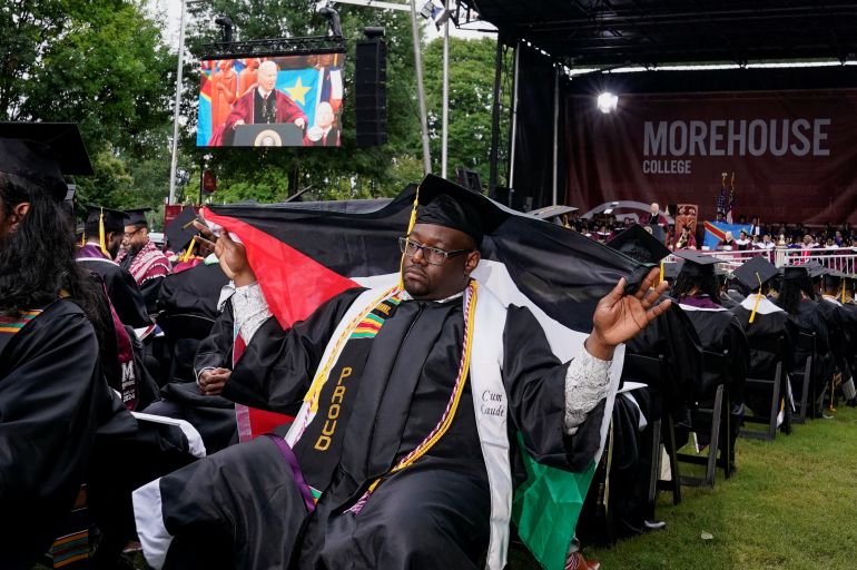 A Morehouse College graduate holds a Palestinian flag while Biden speaks on May 19