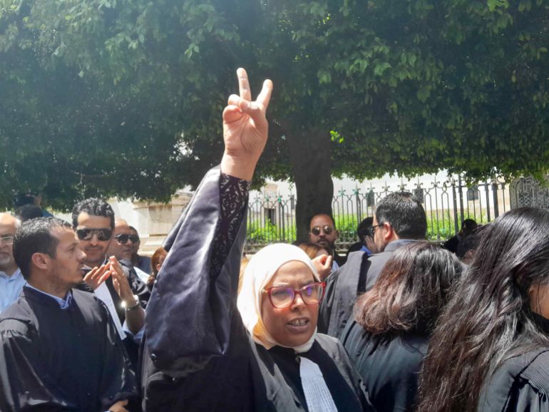 A lawyer protests outside Tunis' principal Court. (Al Jazeera)
