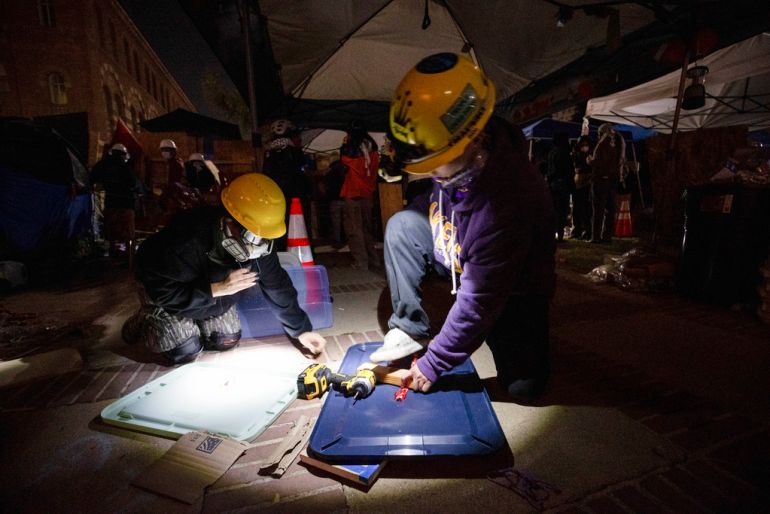 Pro-Palestinian demonstrators build makeshift shields in preparation for the possible clearing of an encampment by authorities on the UCLA campus on May 1 in Los Angeles
