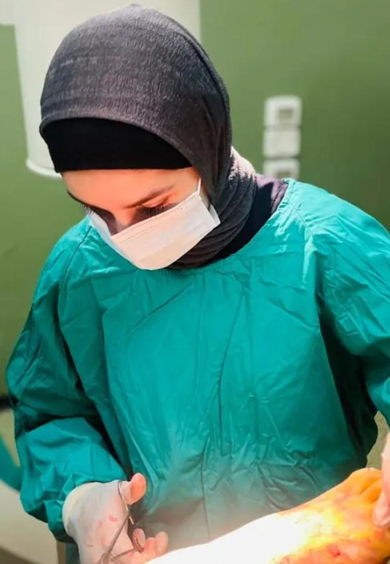 Deema Estez operates on a patient during Gaza’s war. She says she has amputated the limbs of countless children [Courtesy of Deema Estez]