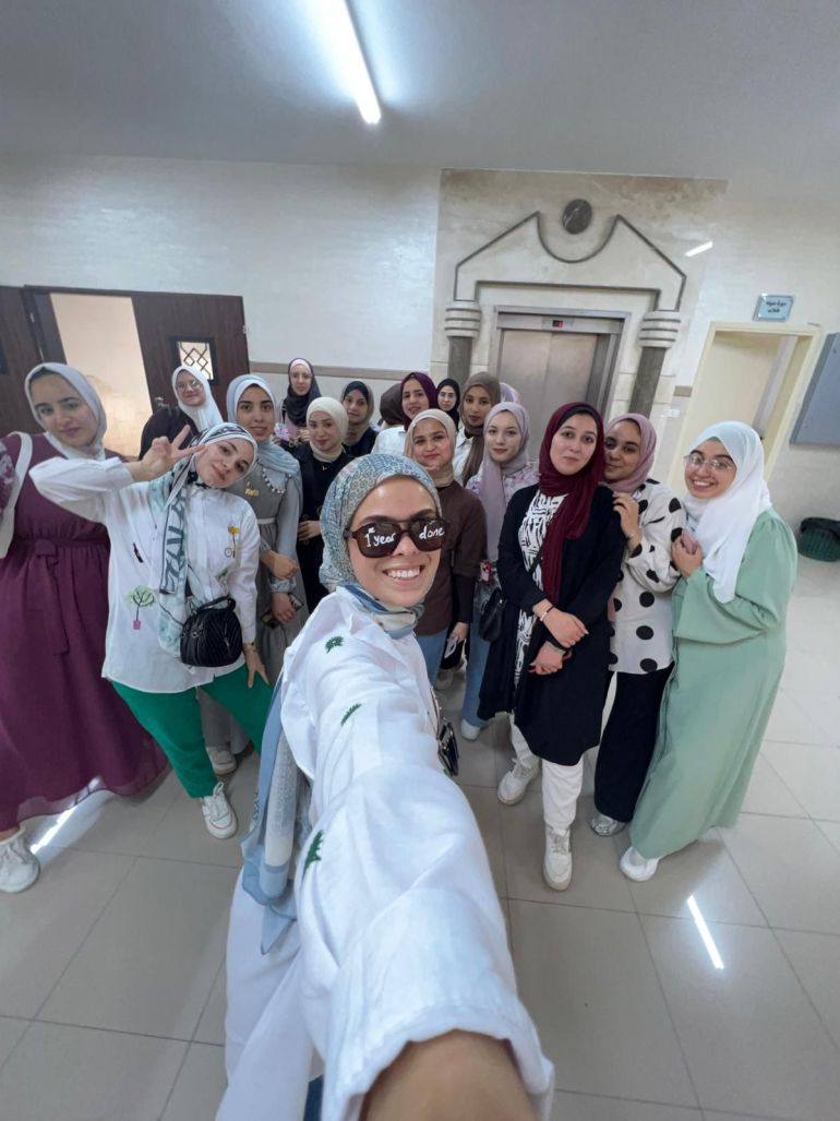 Zahra al-Kurd, front, takes a selfie with her classmates at Al-Azhar University [Courtesy of Zahra al-Kurd]