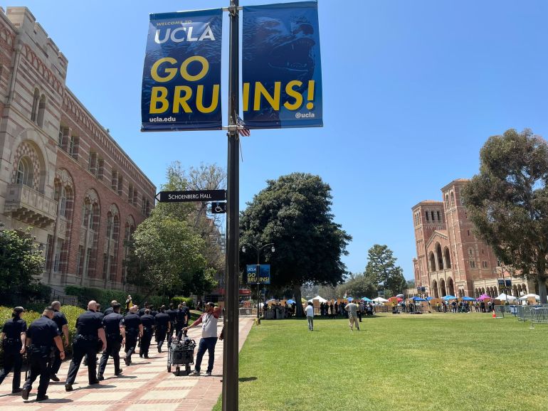Police march in the direction of a pro-Palestine encampment at UCLA in Los Angeles, California, on May 1