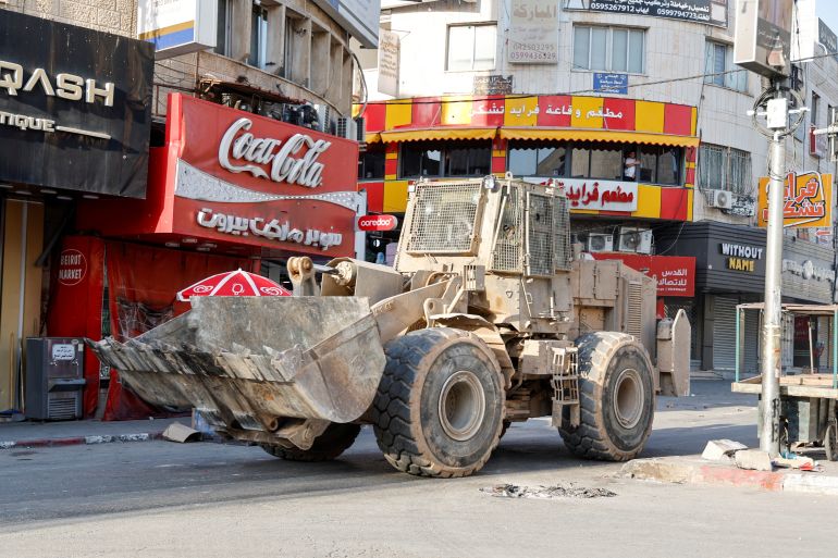 A bulldozer manoeuvres during an Israeli raid in Jenin, in the Israeli-occupied West Bank
