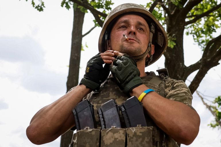 A Ukrainian serviceman of the 33rd Separate Mechanised Brigade smokes during a break as he attends a military drill near a frontline, amid Russia's attack on Ukraine, in Donetsk region, Ukraine June 12, 2024. REUTERS/Alina Smutko