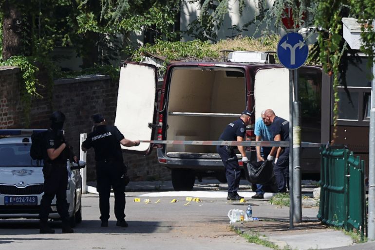 Officers remove the body of the suspect near the Israeli embassy in Belgrade