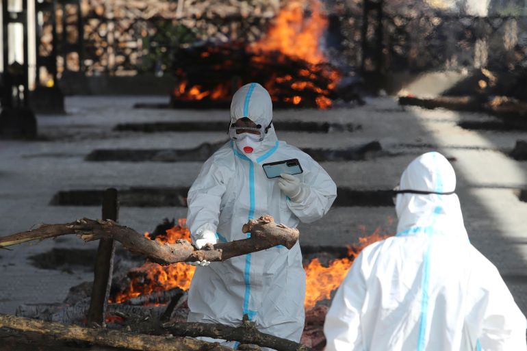 A family member performs the last rites for a COVID-19 victim at a crematorium in Jammu, India, Friday, April 23, 2021. India’s underfunded health system is tattering as the world’s worst coronavirus surge wears out the nation, which set another global record in daily infections for a second straight day with 332,730. India has confirmed 16 million cases so far, second only to the United States in a country of nearly 1.4 billion people. (AP Photo/Channi Anand)
