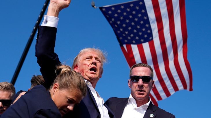 Republican presidential candidate former President Donald Trump is surrounded by U.S. Secret Service agents