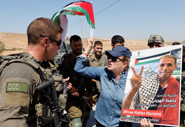 A protester argues with an Israeli soldier during a demonstration against illegal Israeli settlements, in Masafer Yatta, September 17, 2022