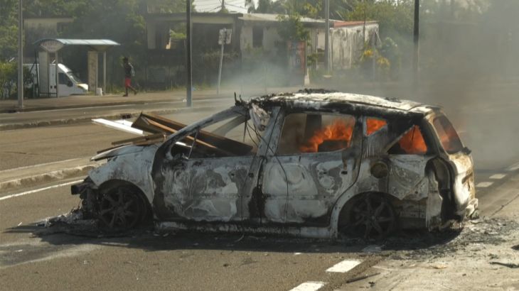TOPSHOT - An image taken from an AFP video released on September 17, 2024 shows a car burning in a street of Fort-de-France in the French Caribbean island of Martinique following a night of riots amid protests over the high cost of living. Officials in the French Caribbean island of Martinique say on September 17, 2024 at least six police officers have been injured by gunfire during violent protests over the high cost of living. Martinique has seen similar protests in recent years, many of them fueled by anger over what demonstrators say is economic, social and racial inequality. (Photo by Thomas THURAR / AFP)