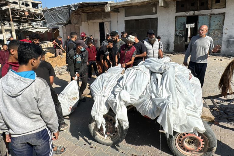 Palestinian transport bodies ahead of their funeral in Beit Lahia