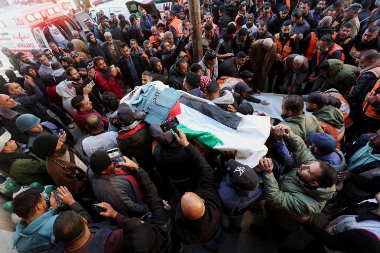 Mourners attend the funeral of Palestinian Ahmed al-Louh, a video journalist for Al Jazeera, and members of the Palestinian Civil Defence who were killed in an Israeli strike on the civil emergency centre, on December 16, 2024