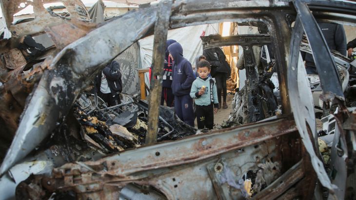 Palestinian children inspect the remains of a car in the aftermath of an Israeli strike in Khan Younis in the southern Gaza Strip, December 23, 2024. [Hatem Khaled/Reuters]