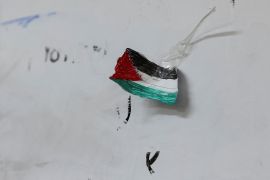 A drawing of a Palestinian flag hangs on a wall.