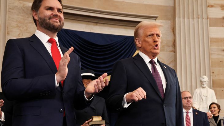 JD Vance and Donald Trump applaud in the Capitol Rotunda.
