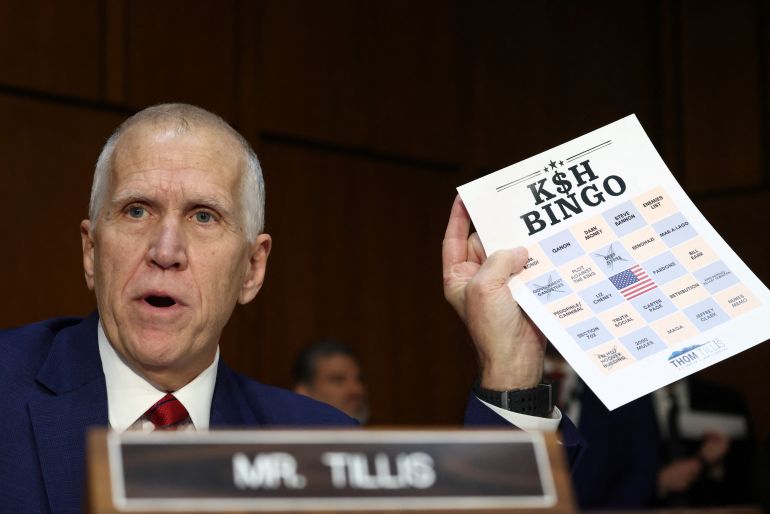 Senator Thom Tillis holds up a ‘bingo card’ of items he anticipates to be raised during Patel’s hearing