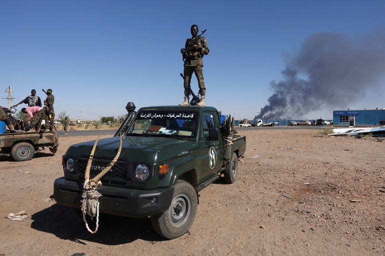 A Sudanese soldier atop a vehicle after the army’s recapture of an oil refinery in Khartoum North
