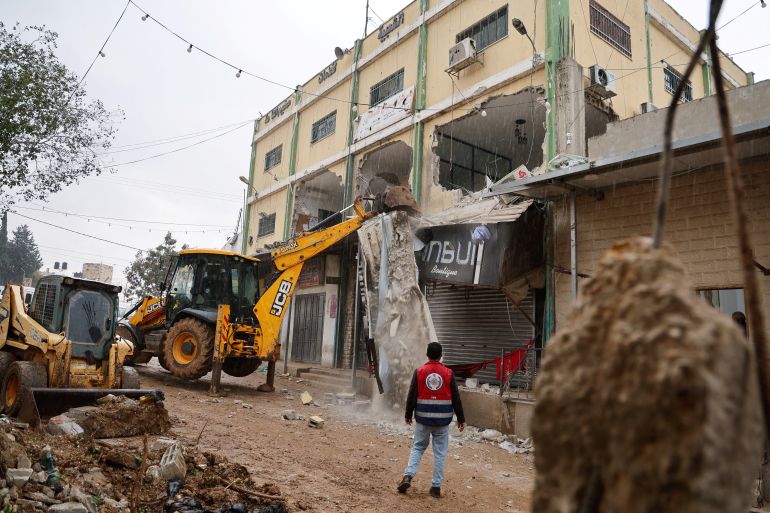 Palestinians remove rubble from a damaged building in the aftermath of an Israeli raid in Far’a refugee camp near Tubas, in the occupied West Bank