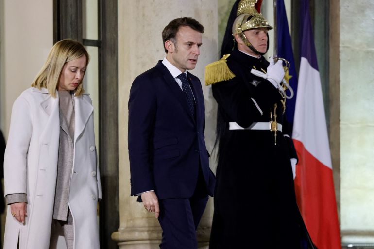 French President Emmanuel Macron (C) walks with Italy's Prime Minister Giorgia Meloni (L) after an informal summit of European leaders to discuss the situation in Ukraine and European security at the Elysee Palace in Paris on February 17, 2025. European leaders were due to meet in Paris on February 17, 2025 to address Washington's shock policy shift on the war in Ukraine, as Britain declared itself ready to dispatch peacekeeping troops to Ukraine. (Photo by Ludovic MARIN / AFP)