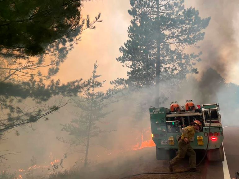 Firefighters battle a wildfire on Monday, August 23, 2021, near Greenwood Lake in the Superior National Forest of northeastern Minnesota. The fire had burned more than 14 square miles (36sq km) and prompted a new round of evacuations of homes and cabins that day [United States Forest Service via AP]
