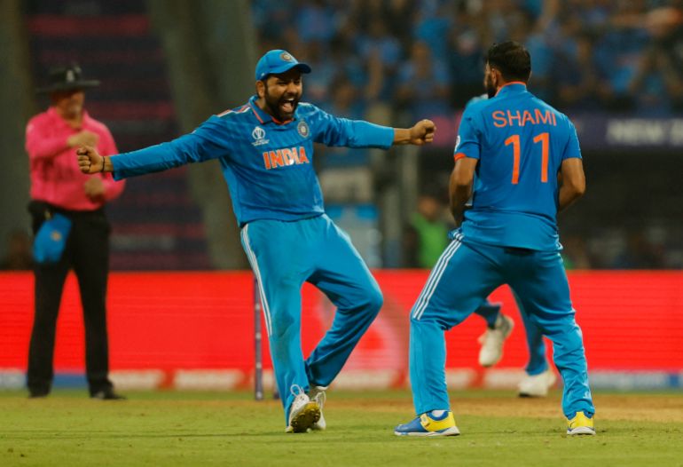 Cricket - ICC Cricket World Cup 2023 - Semi-Final - India v New Zealand - Wankhede Stadium, Mumbai, India - November 15, 2023 India's Mohammed Shami celebrates with Rohit Sharma after taking the lbw wicket of New Zealand's Tom Latham REUTERS/Francis Mascarenhas
