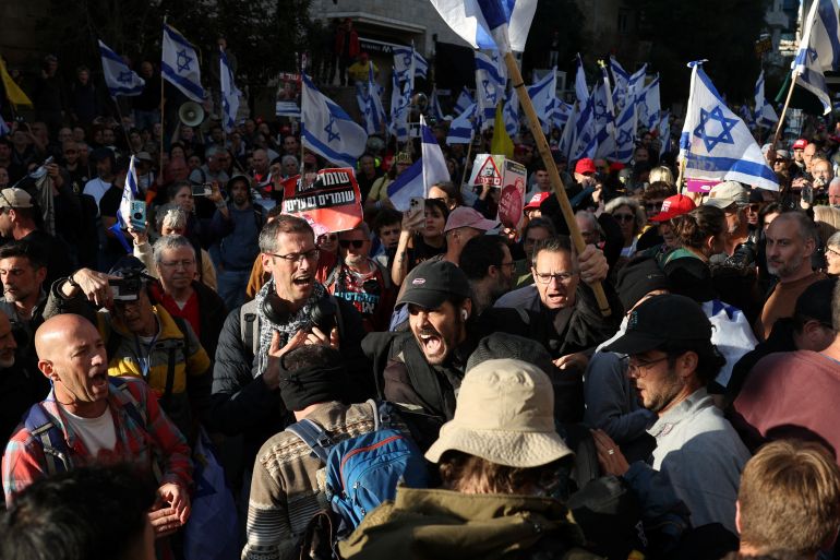 People react during a protest against moves by the Israeli government.