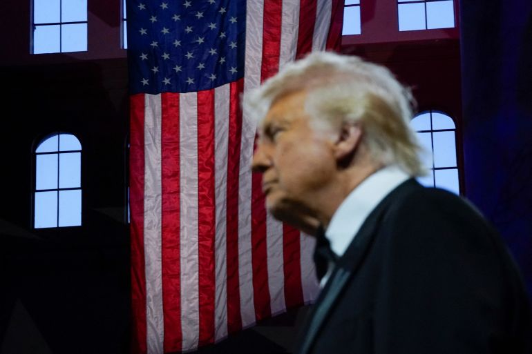 Trump with a United States flag behind him.