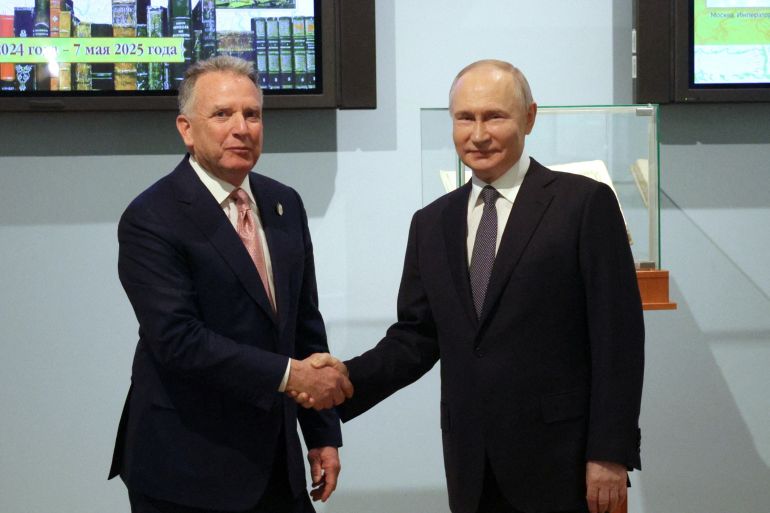 Witkoff and Putin shake hands.