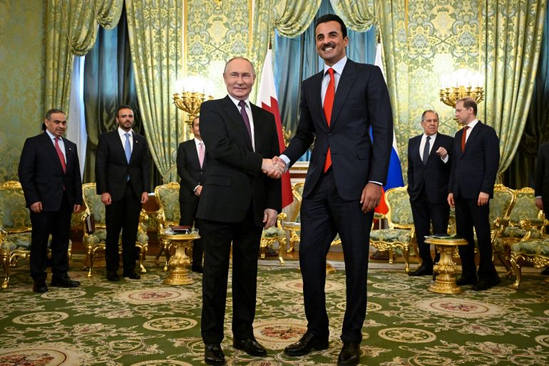 Russia's President Vladimir Putin shakes hands with Qatar's Emir, Sheikh Tamim bin Hamad Al Thani during a meeting at the Kremlin in Moscow, Russia