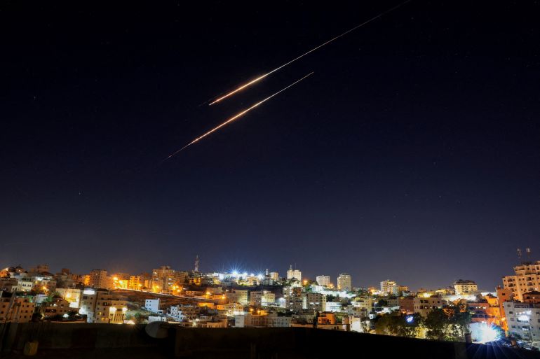 Missiles launched from Iran towards Israel are seen from Hebron, in the Israeli-occupied West Bank, June 19, 2025. [Mussa Issa Qawasma/Reuters]