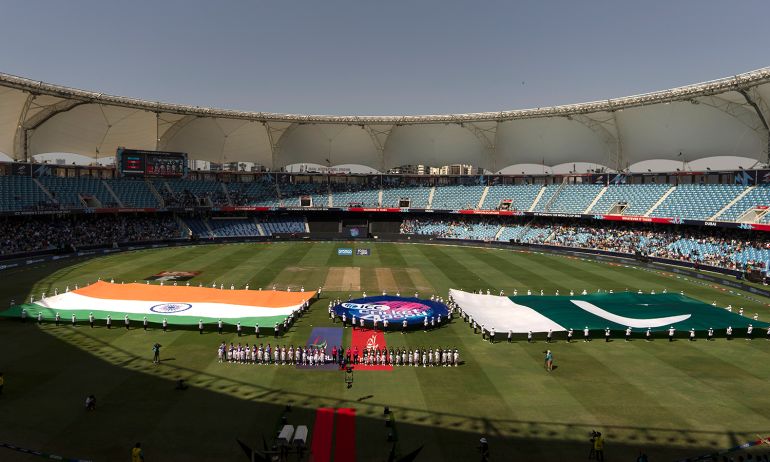 Indian, left, and Pakistan players stand for their national anthem before the start of the ICC Women's T20 World Cup 2024 match between Pakistan and India at Dubai International Stadium, United Arab Emirates, Sunday, Oct. 6, 2024. (AP Photo/Altaf Qadri)