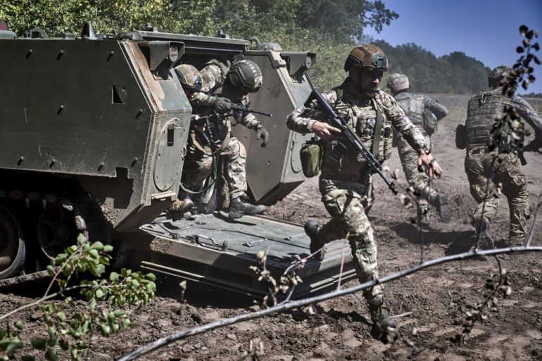 Ukrainian servicemen of the 13th Operational Brigade of the Ukrainian National Guard attend training, including practicing landing and loading into an American M113 armored personnel carrier at a shooting range in the Kharkiv region, Ukraine, 29 August 2025, amid the ongoing Russian invasion. EPA/SERGEY KOZLOV