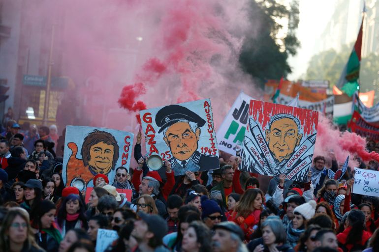 Protesters hold signs denouncing President Javier Milei and Israeli Prime Minister Benjamin Netanyahu in Buenos Aires, Argentina, on August 9