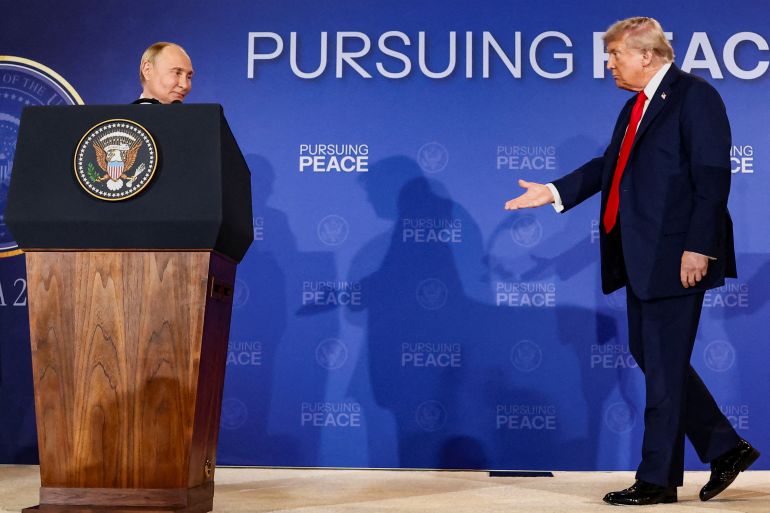 U.S. President Donald Trump walks towards Russian President Vladimir Putin during a press conference following their meeting to negotiate an end to the war in Ukraine, at Joint Base Elmendorf-Richardson, in Anchorage, Alaska, U.S., August 15, 2025. REUTERS/Kevin Lamarque TPX IMAGES OF THE DAY