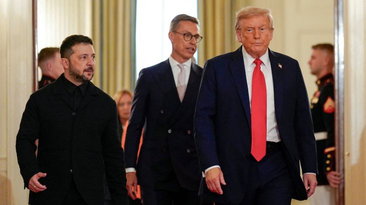 U.S. President Donald Trump and Ukrainian President Volodymyr Zelenskiy walk during a meeting, amid negotiations to end the Russian war in Ukraine