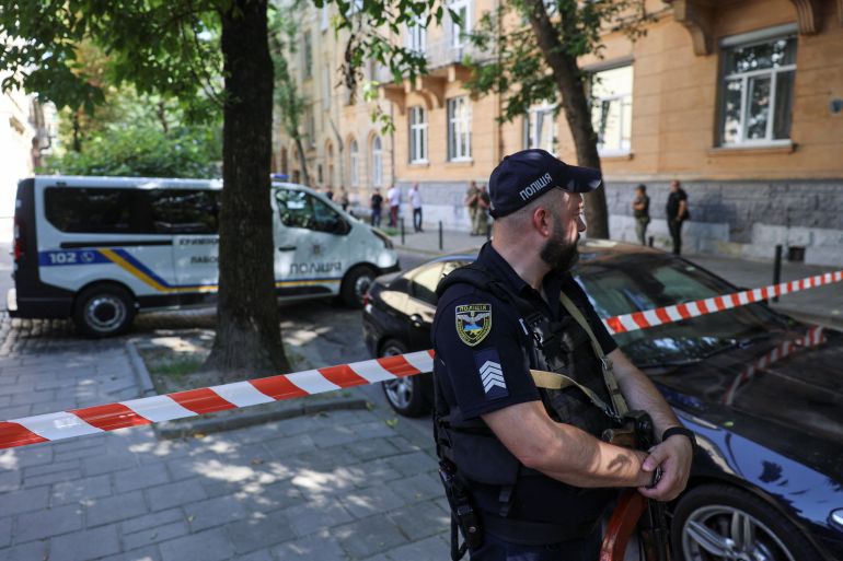 A police officer guards the site of Parubiy’s killing in Lviv, Ukraine, August 30