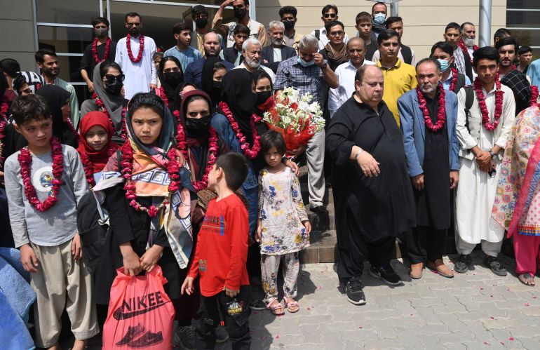 Members of Afghanistan's women soccer team and their families pose for a photograph after they were greeted by officials of the Pakistan Football Federation, in Lahore, Pakistan, Wednesday, Sept. 15, 2021