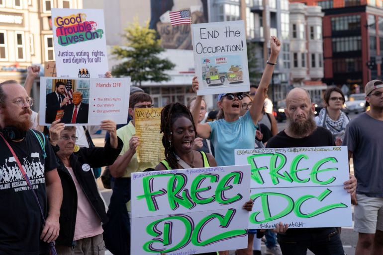 people hold signs saying Free DC at a protest