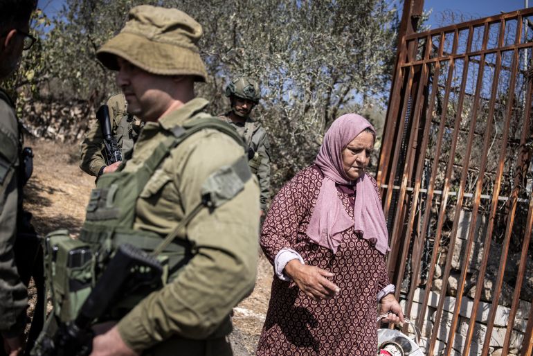 Israeli soldiers block the entrance to a Palestinian olive field near the illegal settlement of Elazar, south of Bethlehem, in the occupied West Bank, on October 17, 2025 [AFP]