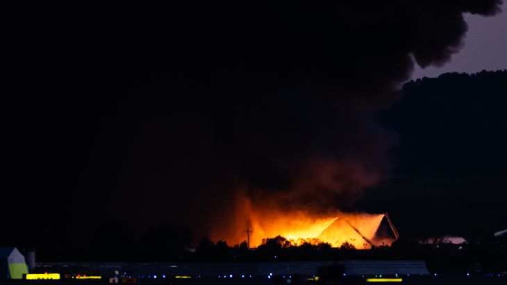 A plume of smoke rises from the site of a UPS cargo plane crash.