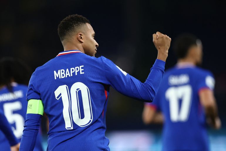 France's Kylian Mbappe celebrates scoring their first goal.
