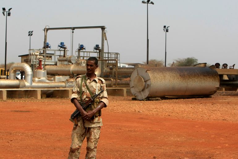 A member of the military stands guard near pump stations before a ceremony in which oil operations at Heglig oilfield will resume in Heglig
