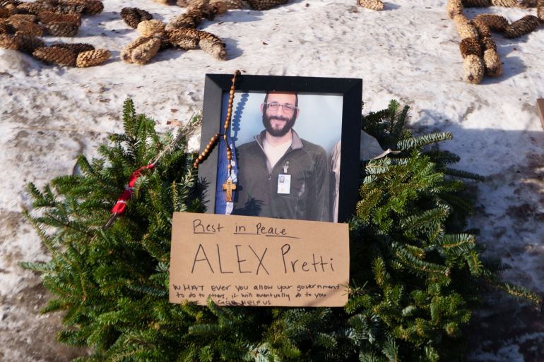 A wreath surrounds an image of Alex Pretti at the makeshift memorial near the site where he was fatally shot by federal agents, in Minneapolis, Minnesota, US, January 26, 2026