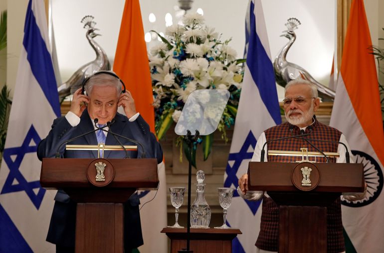 Israeli Prime Minister Benjamin Netanyahu adjusts his headphones as he and his Indian counterpart Narendra Modi attend a signing of agreements ceremony at Hyderabad House in New Delhi, India, January 15, 2018