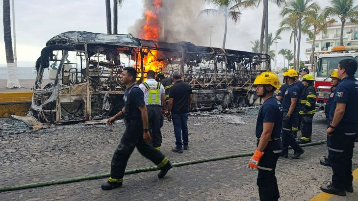 Firefighters work to extinguish flames from buses set on fire by members of organized crime following a military operation in which Mexican officials said cartel boss Nemesio Oseguera, "El Mencho," was killed, at a tourist area, in Puerto Vallarta, Mexico,