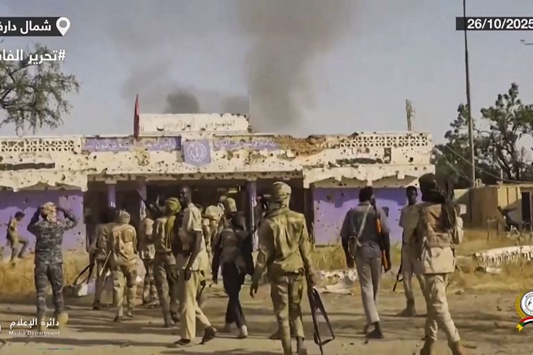 This image grab taken from handout video footage released on Sudan's paramilitary Rapid Support Forces (RSF) Telegram account on October 26, 2025, shows RSF fighters holding weapons and celebrating in the streets of El-Fasher in Sudan's Darfur. The governor of Darfur, allied with the Sudanese army, on October 27, 2025, called for the "protection of civilians" in the famine-stricken city of El-Fasher, after the paramilitary Rapid Support Forces (RSF) claimed to have taken control. (Photo by Rapid Support Forces (RSF) / AFP) / === RESTRICTED TO EDITORIAL USE - MANDATORY CREDIT "AFP PHOTO / HO / SUDAN RAPID SUPPORT FORCES (RSF) TELEGRAM ACCOUNT" - NO MARKETING NO ADVERTISING CAMPAIGNS - DISTRIBUTED AS A SERVICE TO CLIENTS ===
