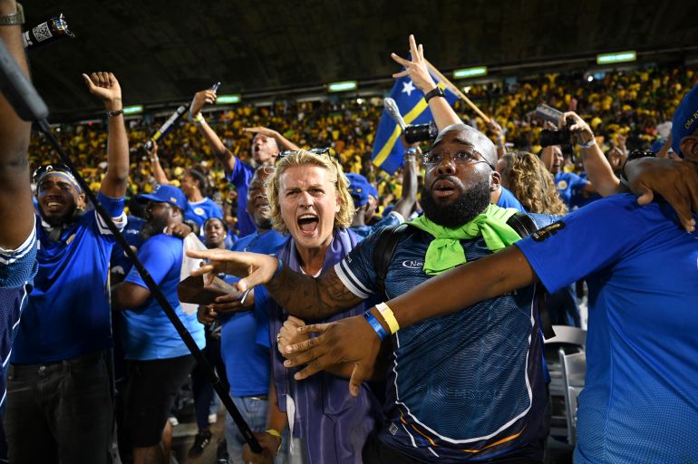 Curaçao fans celebrate World Cup 2026 qualification after a 0-0 draw with Jamaica at the National Stadium in Kingston, Jamaica on November 18, 2025. The tiny Caribbean nation of Curacao became the smallest country ever to qualify for the World Cup on November 18 as Haiti booked their return to the tournament for the first time in 52 years along with Panama.