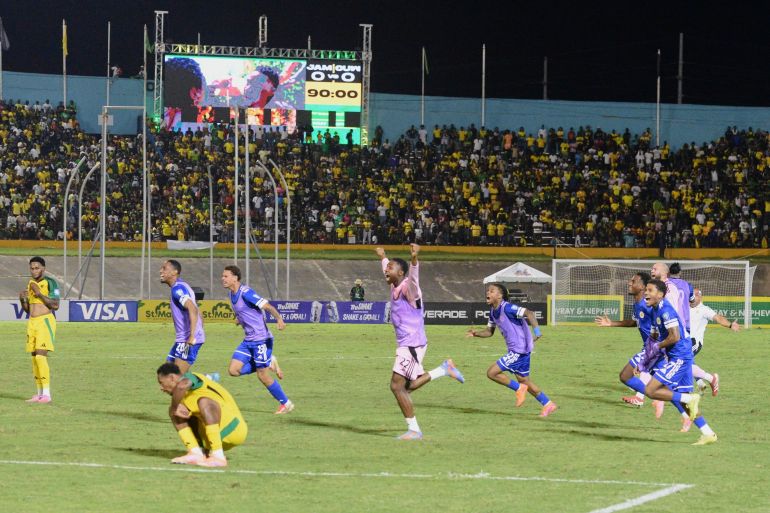 Curacao's players burst into celebrations after holding Jamaica  to a goalless draw, a result which confirmed their World Cup qualification [File: Collin Reid/AP]