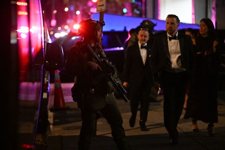 Armed commandos stand by as special guests are evacuated from the back of the Washington Hilton in Washington, DC, on April 25, 2026