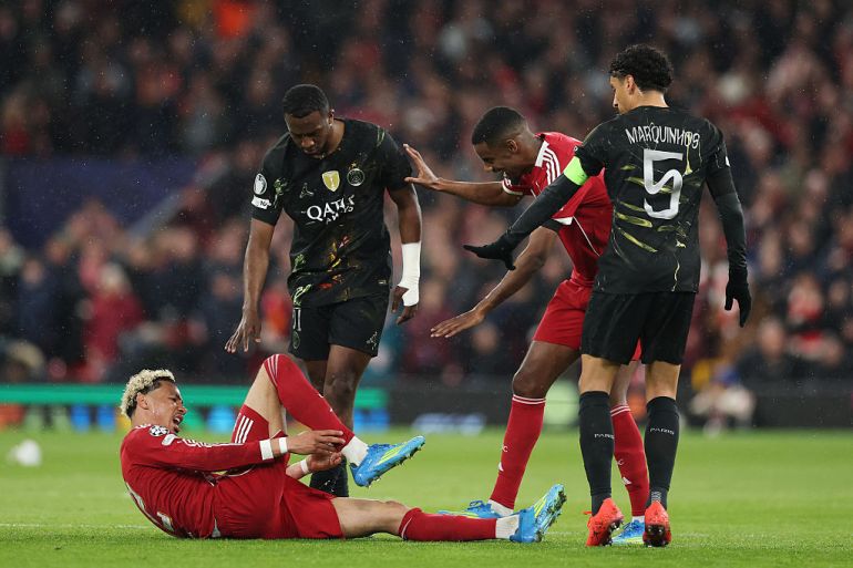 Hugo Ekitike of Liverpool holds his ankle as he appears to be injured during the UEFA Champions League 2025/26 Quarter-Final Second Leg match between Liverpool FC and Paris Saint-Germain FC at Anfield
